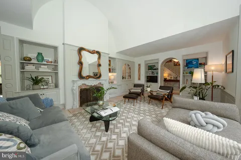a living room with a flat screen tv and a fireplace