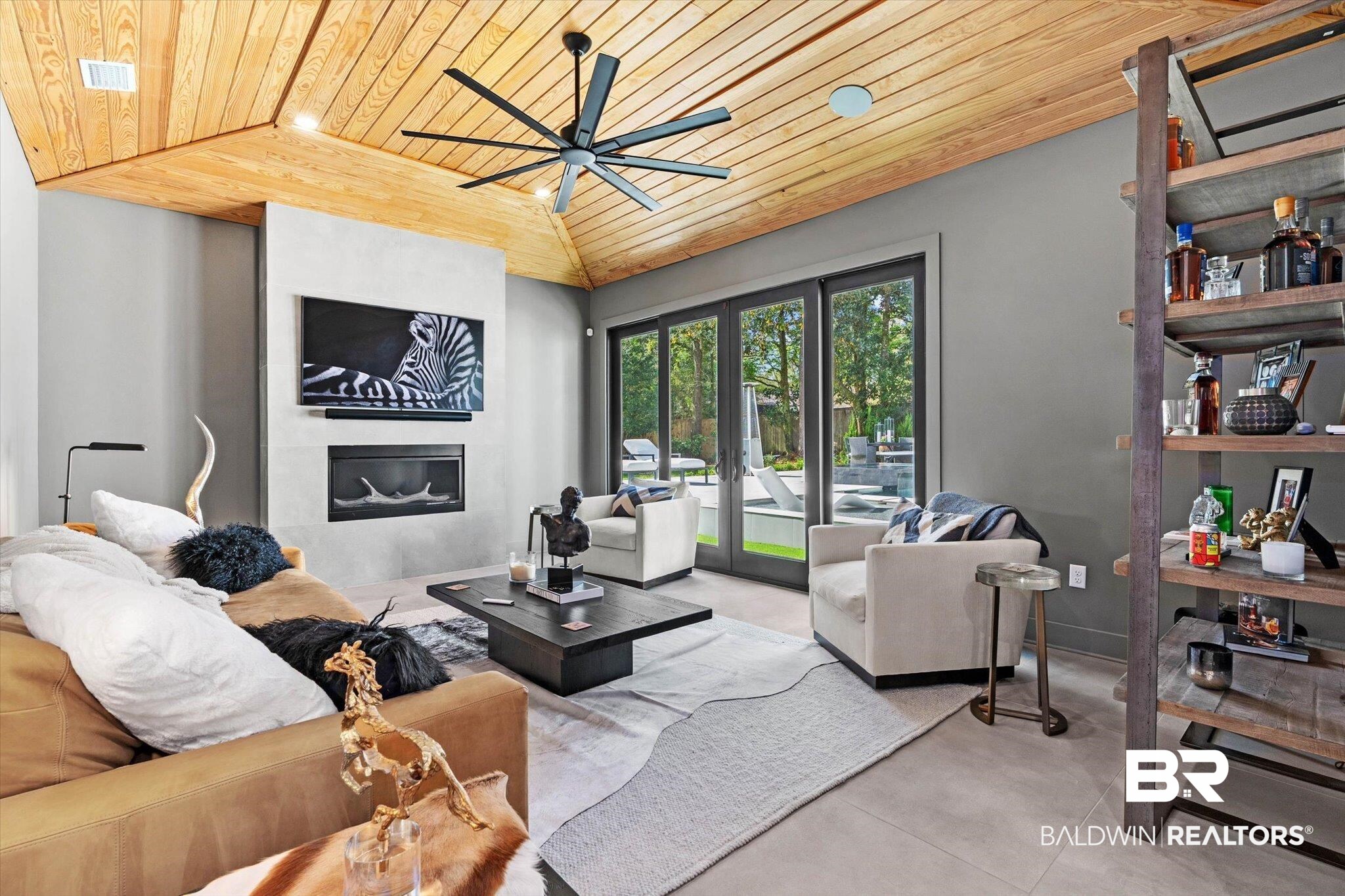69 Jordan Lane Mobile, AL 36608 - Photo 13 of 57 Living area with a vaulted wooden ceiling, a large fireplace, concrete floors, and ceiling fan