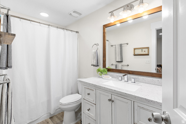 912 North Loafer Canyon Road Elk Ridge, UT 84651 - Photo 43 of 98 White vanity with shaker-style cabinetry, a white countertop, and an integrated rectangular sink