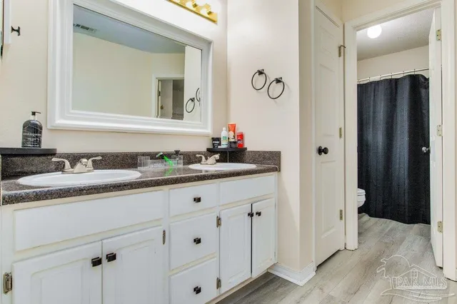 a bathroom with a toilet and a shower curtain