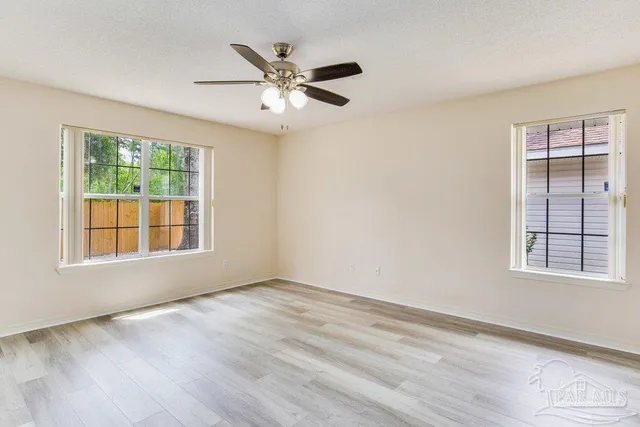 wooden floor in an empty room with a window