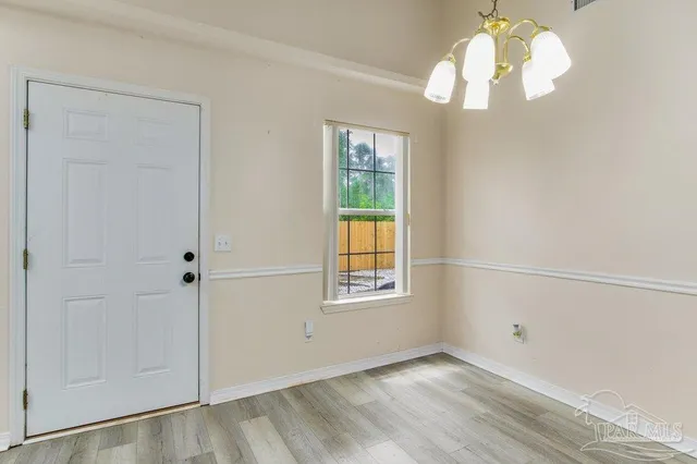 a kitchen with stainless steel appliances white cabinets and a stove top oven