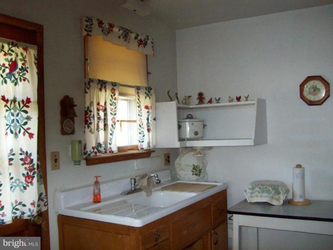 3538 Basler Road Hampstead, MD 21074 - Photo 4 of 14 a bathroom with a sink and a mirror