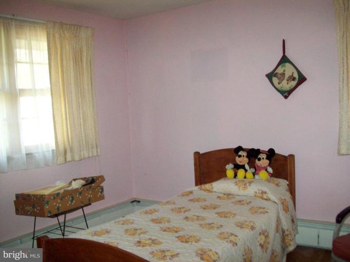 3538 Basler Road Hampstead, MD 21074 - Photo 10 of 14 a bedroom with a bed and a table in it
