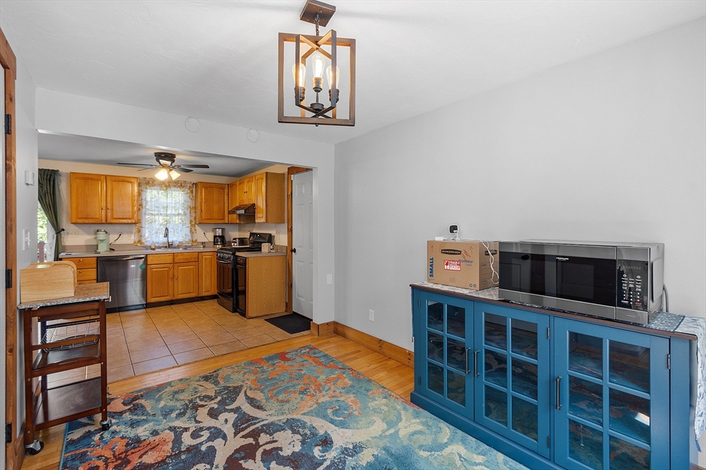 76 Ferin Road Ashburnham, MA 01430 - Photo 12 of 41 a kitchen with stainless steel appliances wooden floor and a view of living room