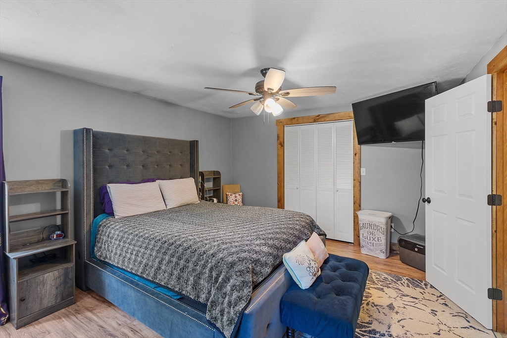 76 Ferin Road Ashburnham, MA 01430 - Photo 15 of 41 a bedroom with a bed and a chandelier