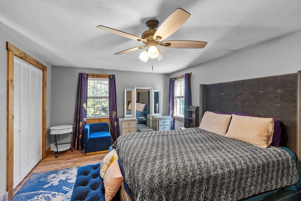 76 Ferin Road Ashburnham, MA 01430 - Photo 16 of 41 a bedroom with a bed and a chandelier