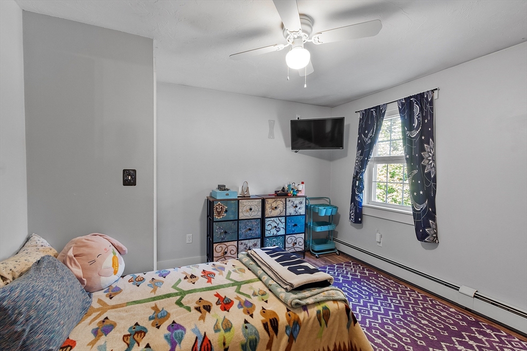 76 Ferin Road Ashburnham, MA 01430 - Photo 17 of 41 a bedroom with a bed and a chandelier