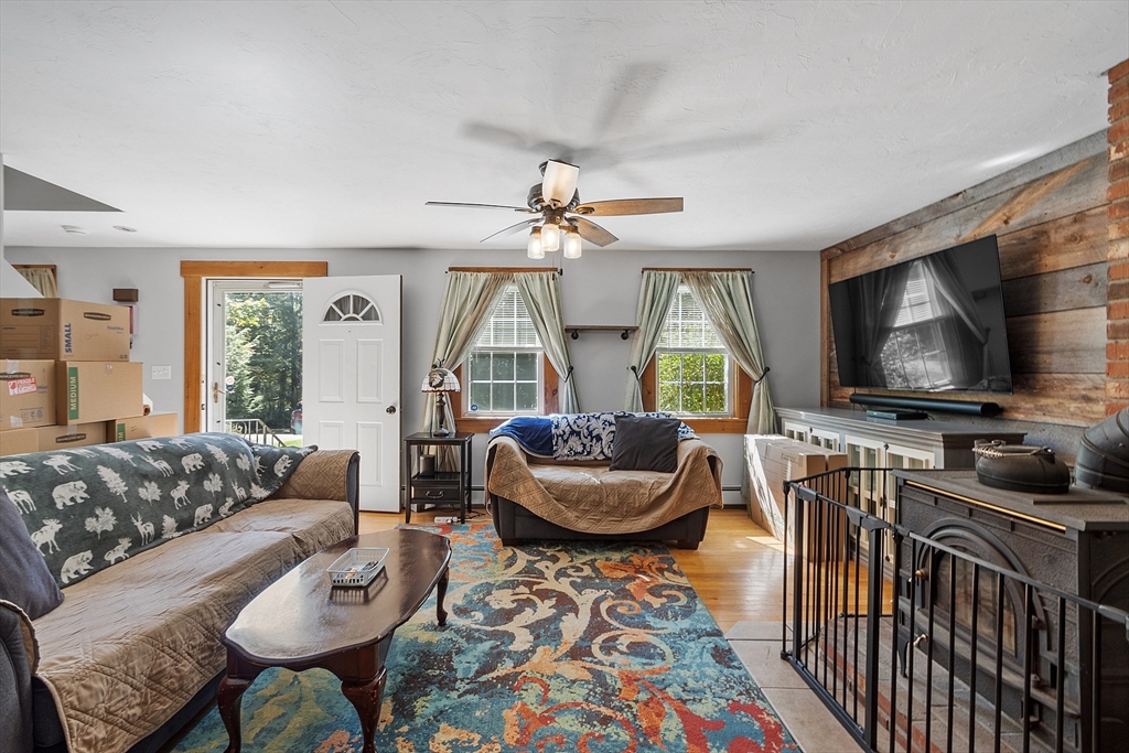 76 Ferin Road Ashburnham, MA 01430 - Photo 4 of 41 a living room with furniture and a flat screen tv