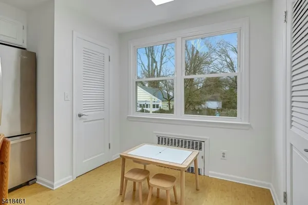 a bedroom with a bed wall painting and a window