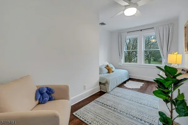 a view of a chair and table in backyard of the house