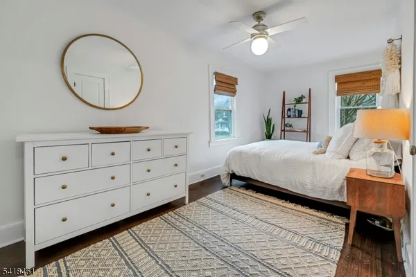 a view of a wooden bench sitting in backyard of house