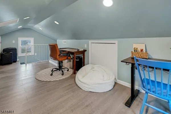 a front view of a house with a yard and potted plants
