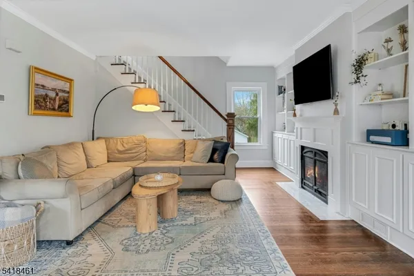 a living room with a fireplace and a flat screen tv