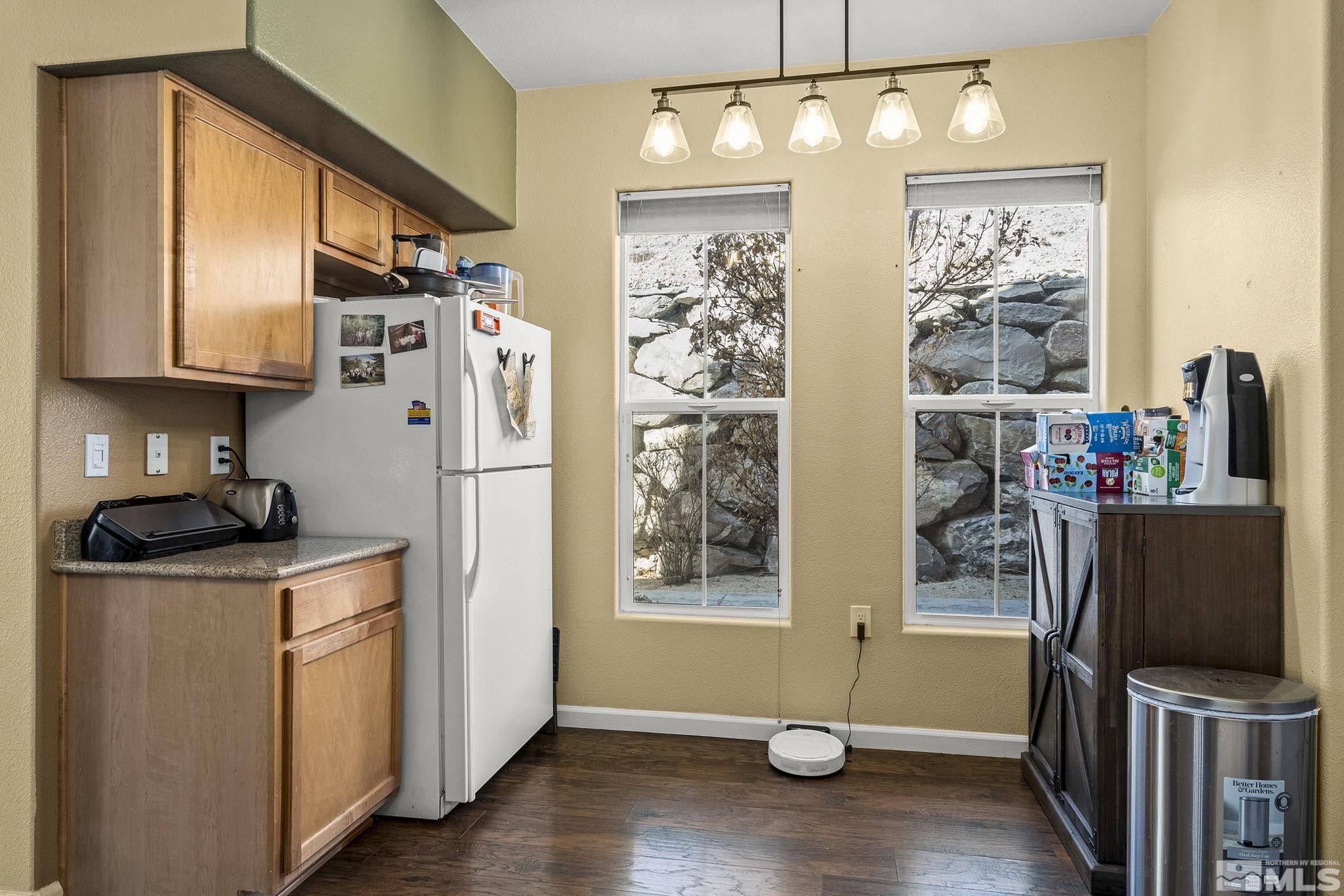 9050 Double R Boulevard, Unit 1211 Reno, NV 89521 - Photo 12 of 20 a kitchen with stainless steel appliances granite countertop a refrigerator a stove top oven a sink and dishwasher