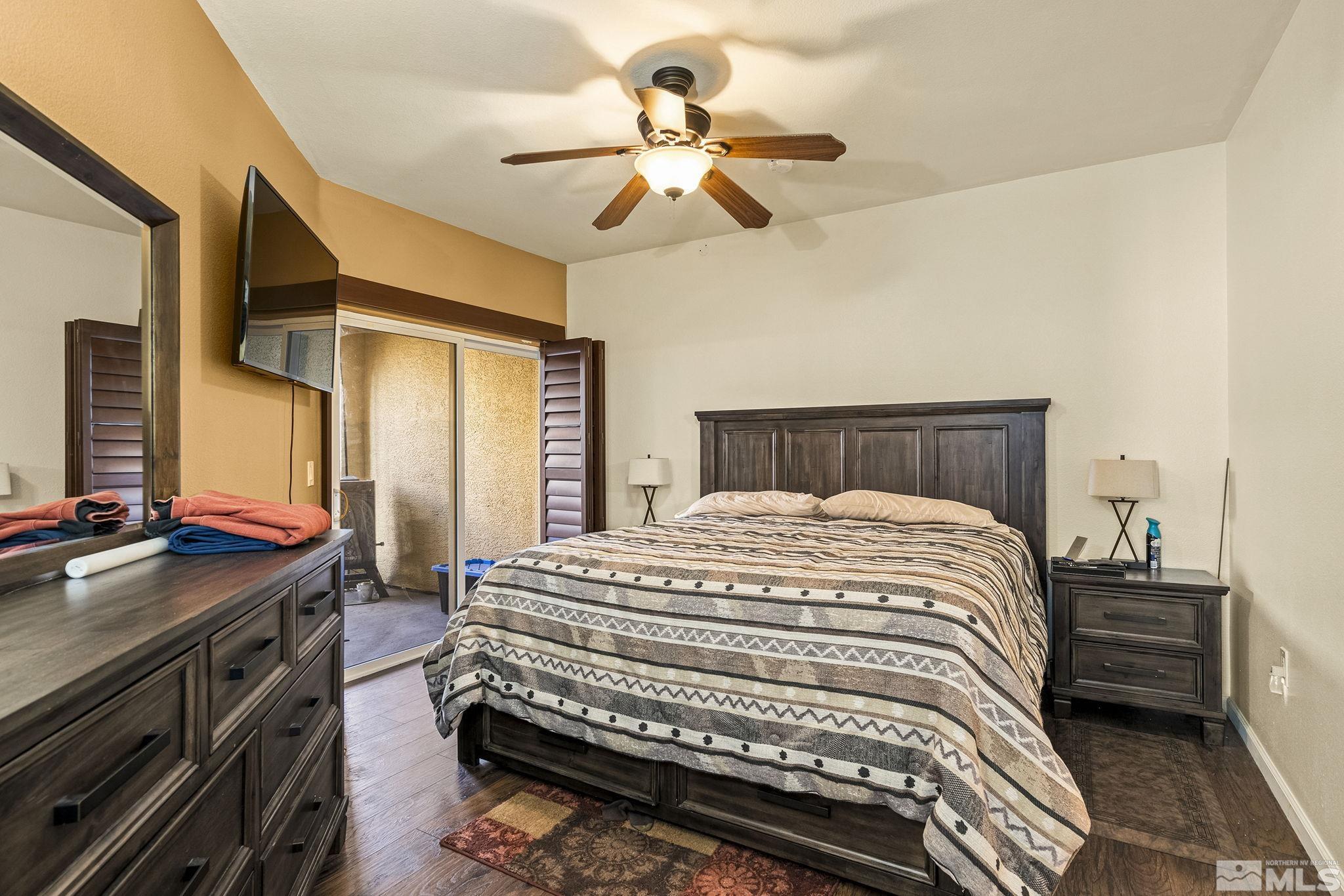 9050 Double R Boulevard, Unit 1211 Reno, NV 89521 - Photo 13 of 20 a bedroom with a bed and a chandelier