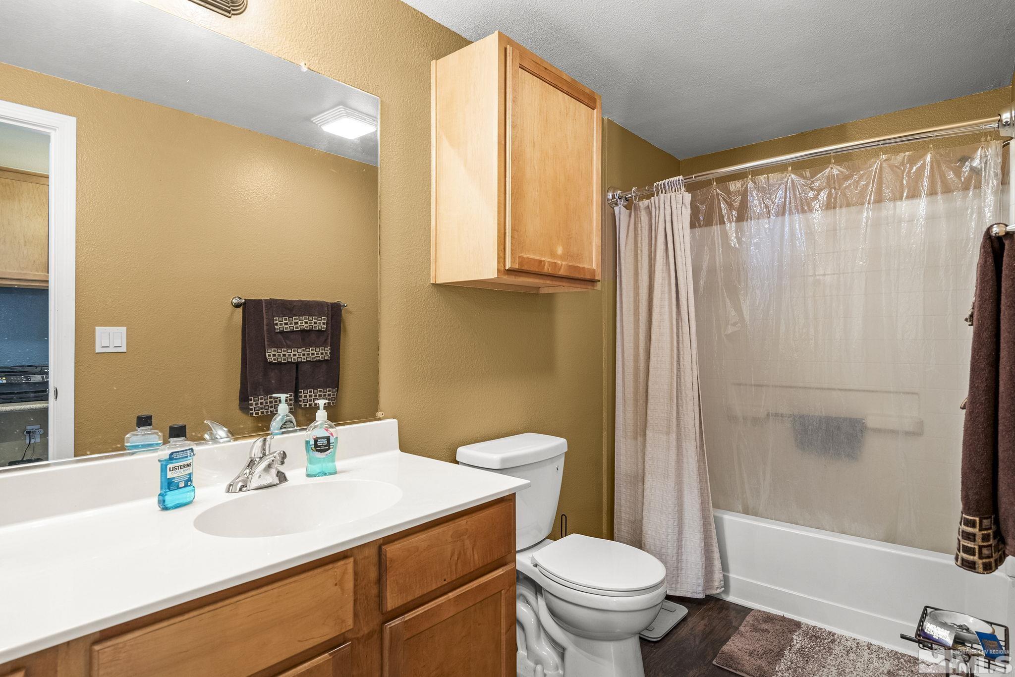 9050 Double R Boulevard, Unit 1211 Reno, NV 89521 - Photo 18 of 20 a bathroom with a sink a toilet and shower