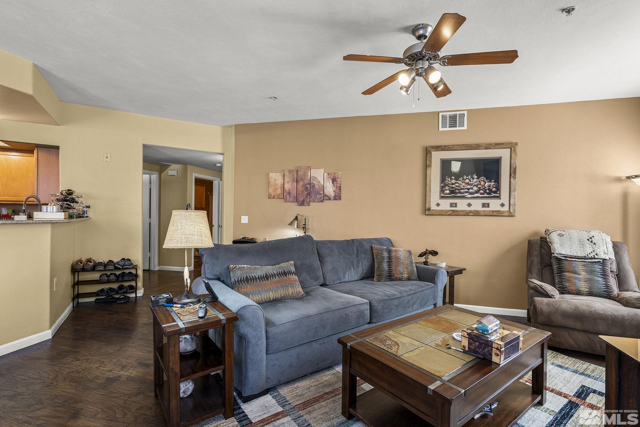 9050 Double R Boulevard, Unit 1211 Reno, NV 89521 - Photo 4 of 20 a living room with furniture and a view of kitchen