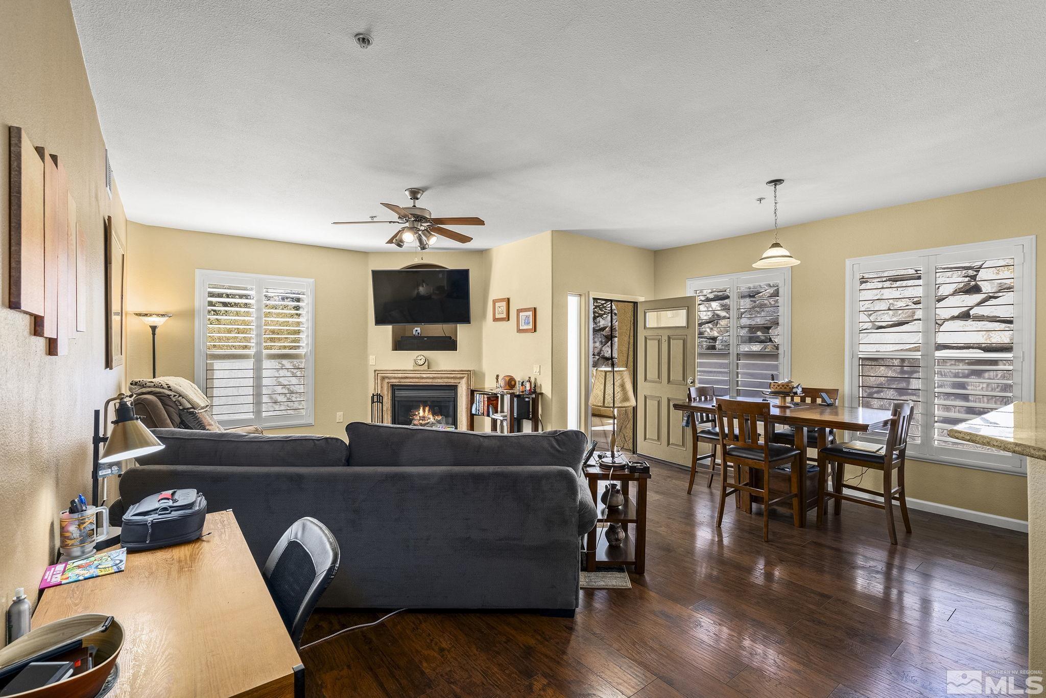 9050 Double R Boulevard, Unit 1211 Reno, NV 89521 - Photo 7 of 20 a living room with furniture flat screen tv and wooden floor