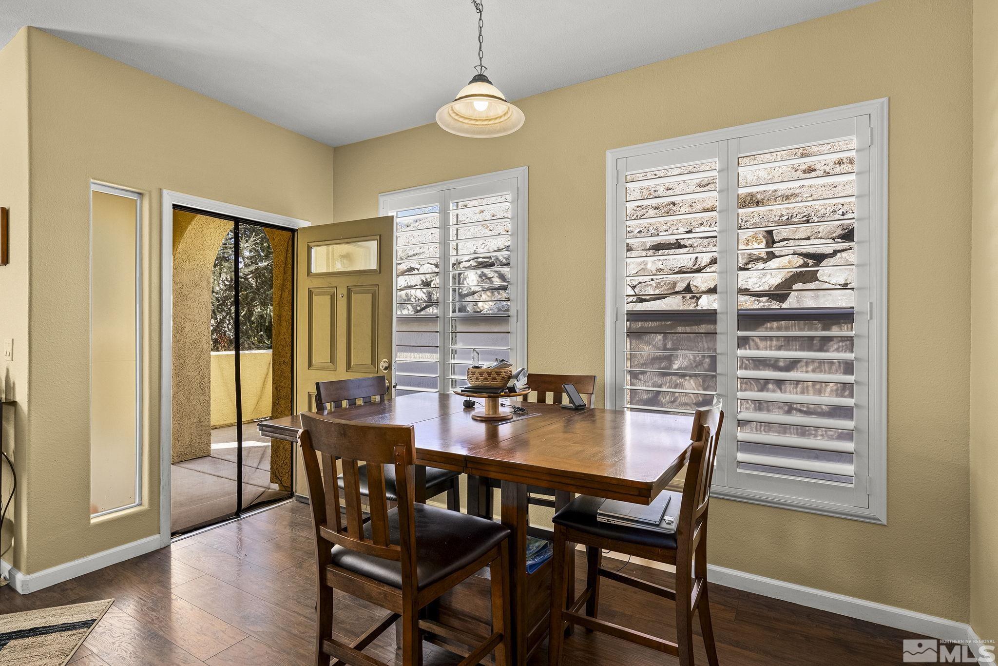 9050 Double R Boulevard, Unit 1211 Reno, NV 89521 - Photo 8 of 20 a view of a dining room with furniture window and wooden floor