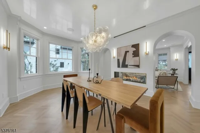 a large kitchen with stainless steel appliances a large counter top a stove a chimney a sink and a large window