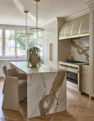 a kitchen with stainless steel appliances a dining table chairs and couches