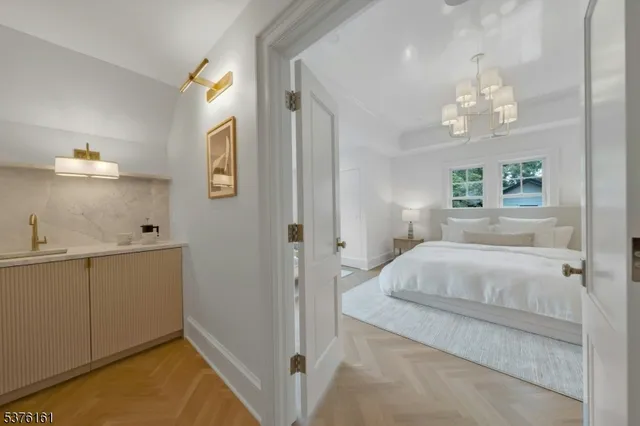 a bedroom with a bed and a chandelier