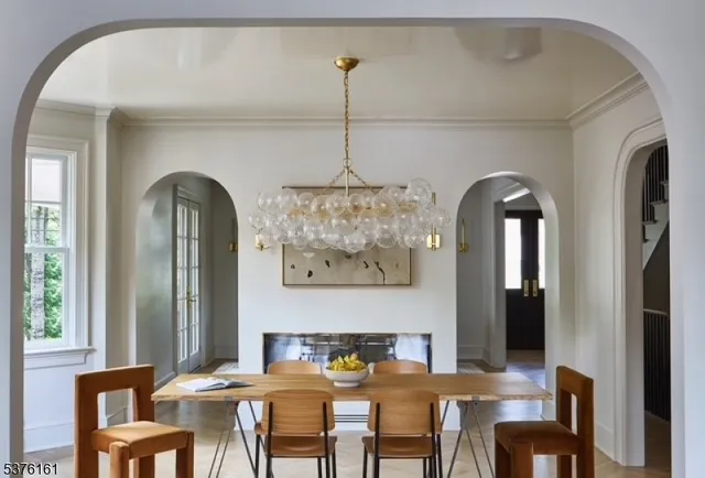 a view of a dining room with furniture a chandelier and wooden floor