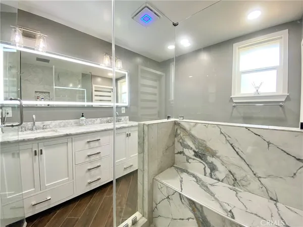 a bathroom with a granite countertop sink mirror and double