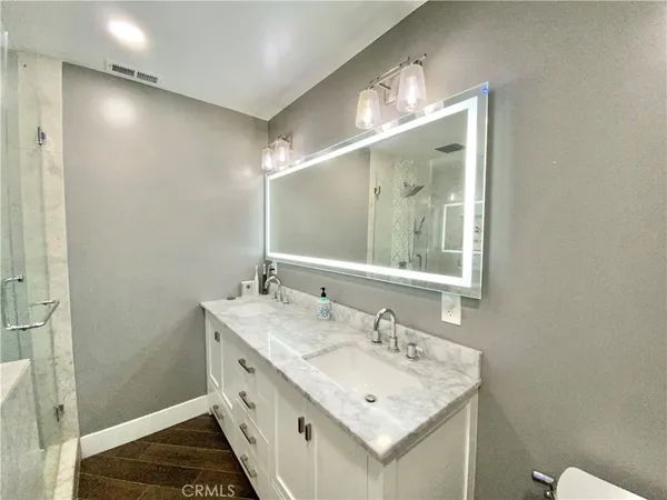 a bathroom with a double vanity sink and a mirror