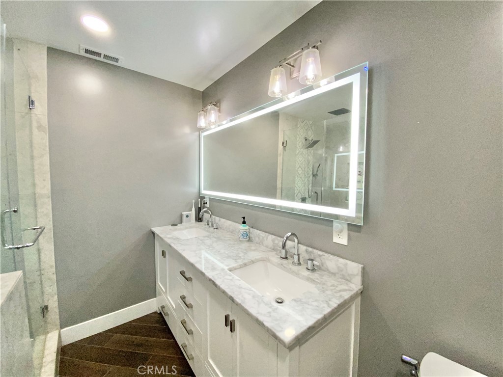 15925 Winchester Way Riverside, CA 92508 - Photo 18 of 25 a bathroom with a double vanity sink and a mirror