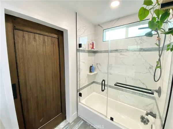 a bathroom with a bathtub and a shower