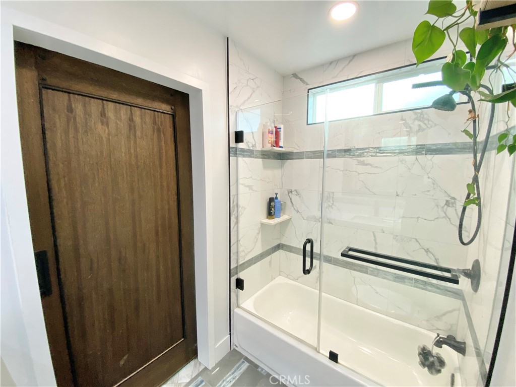 15925 Winchester Way Riverside, CA 92508 - Photo 20 of 25 a bathroom with a bathtub and a shower