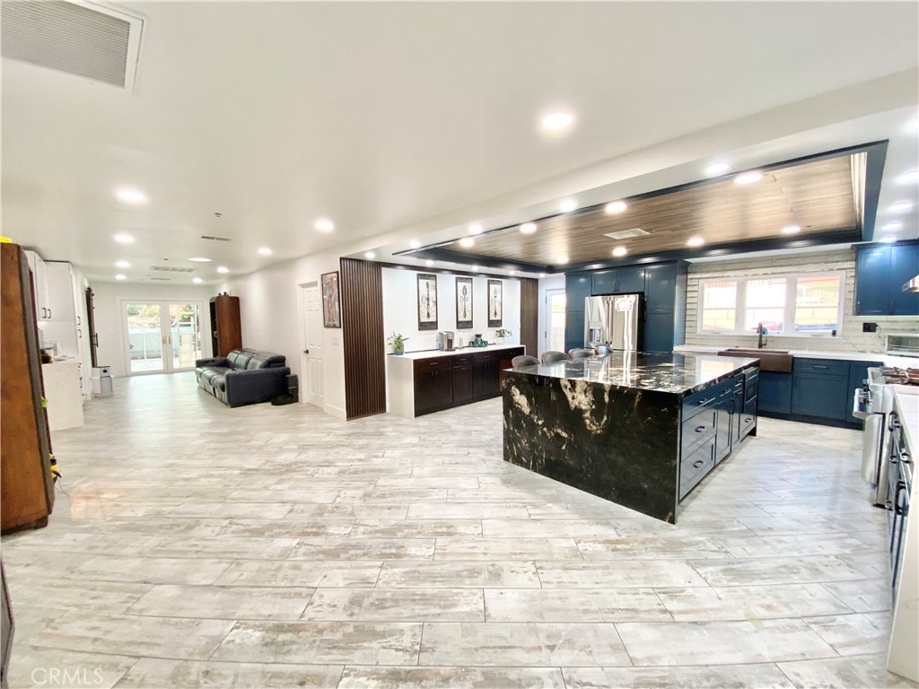 15925 Winchester Way Riverside, CA 92508 - Photo 3 of 25 a large kitchen with stainless steel appliances kitchen island a large counter top a refrigerator and a sink