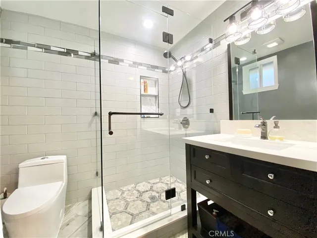 a bathroom with a double vanity sink mirror and shower