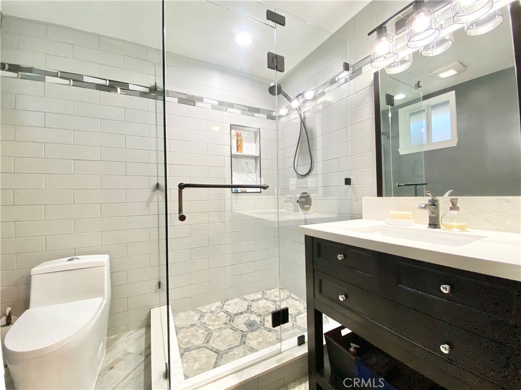 15925 Winchester Way Riverside, CA 92508 - Photo 8 of 25 a bathroom with a double vanity sink mirror and shower