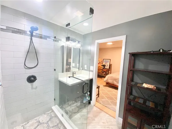 a bathroom with a shower tub and mirror