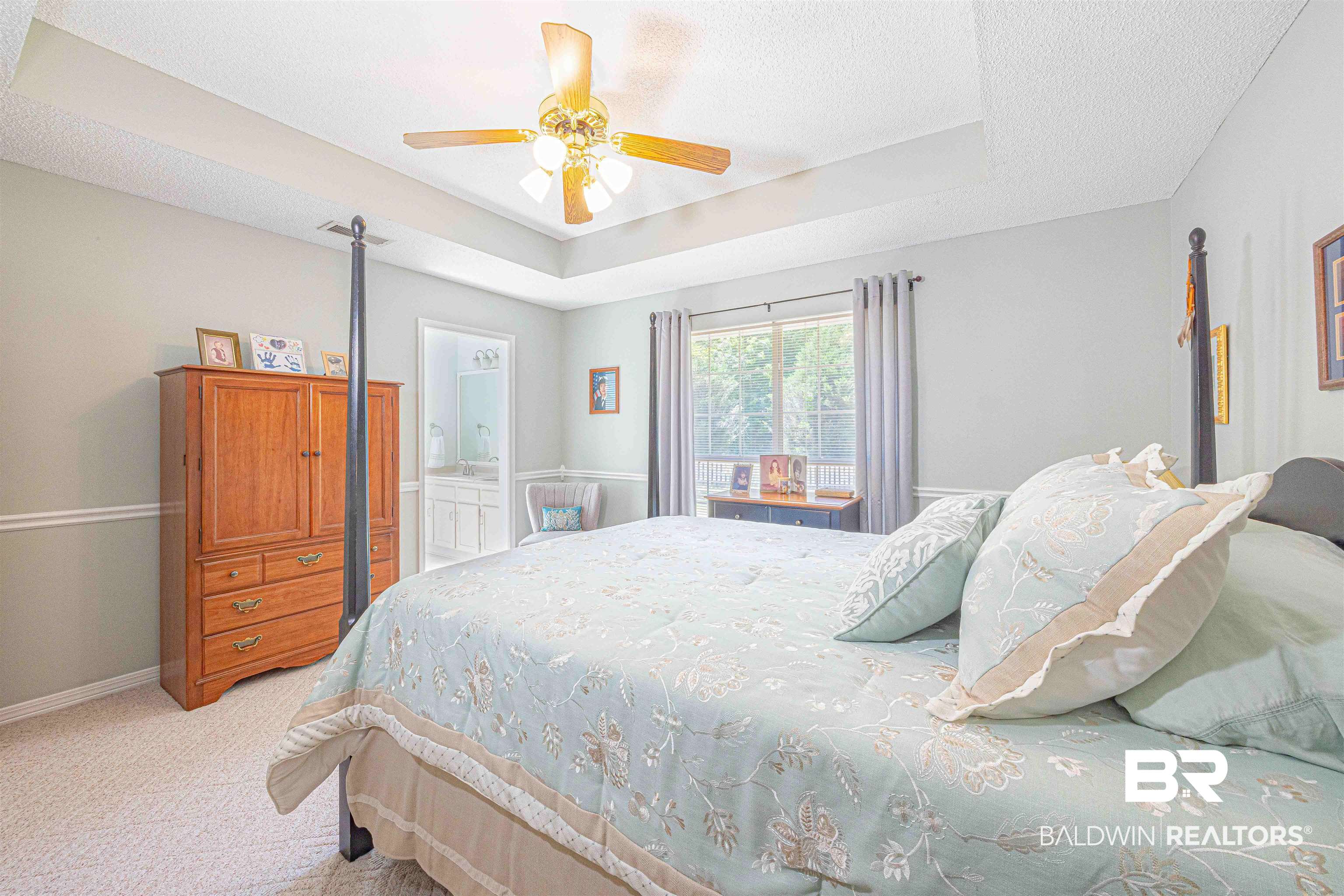 485 Ridgewood Drive Daphne, AL 36526 - Photo 23 of 38 Bedroom featuring light carpet, a tray ceiling, a textured ceiling, baseboards, and a ceiling fan
