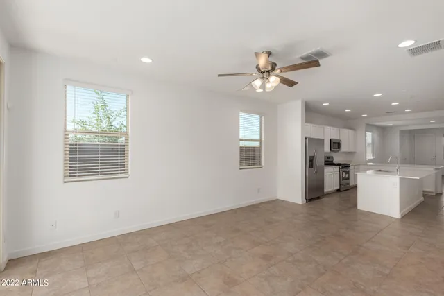 a kitchen with white cabinets a sink and dishwasher