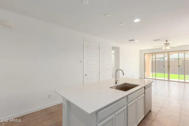 a view of a kitchen with white cabinets