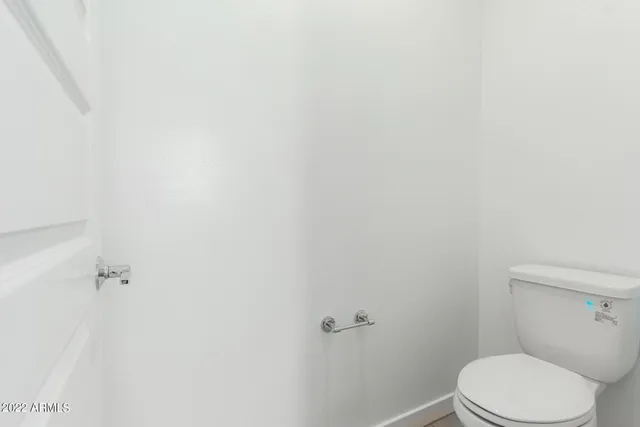 an empty room with a ceiling fan and a window