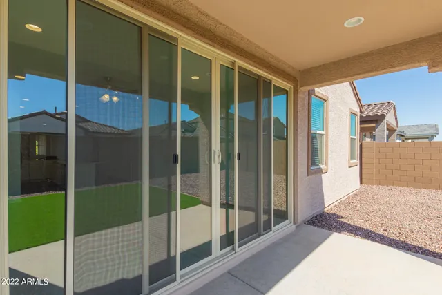 a view of a house with a yard and pathway