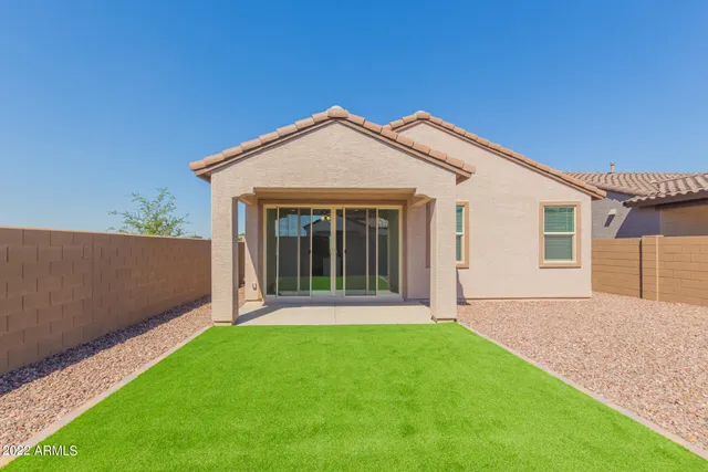 a front view of a house with garage and yard