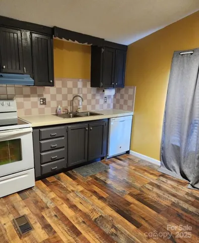 a kitchen with stainless steel appliances granite countertop a sink and cabinets