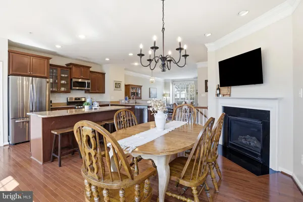 a view of a dining room with furniture wooden floor and a chandelier