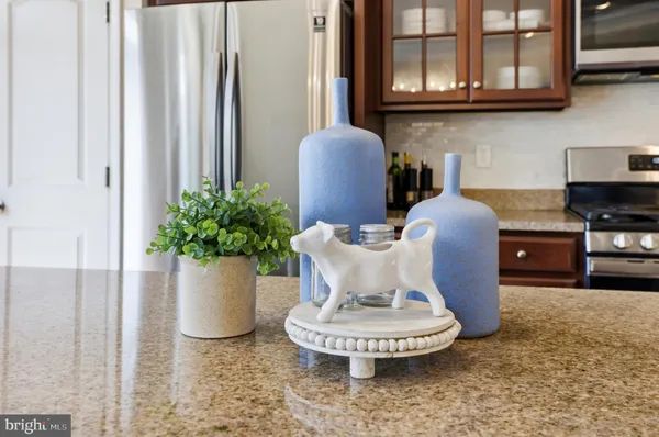 a white vase with flowers on a dining table