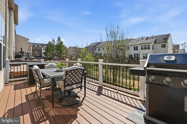 a view of a dinning table and chairs in patio of the house