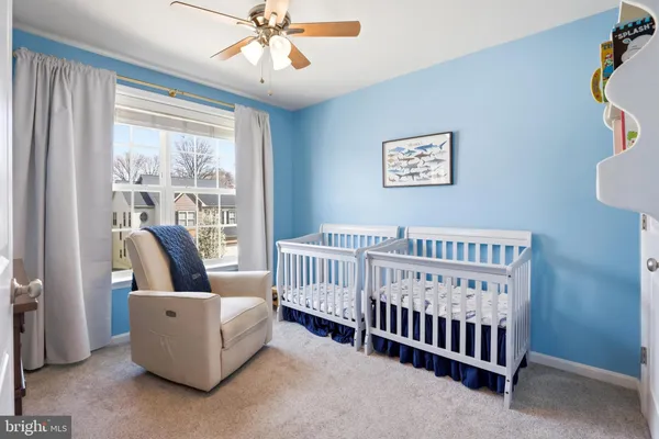 a view of a livingroom with furniture and chandelier fan