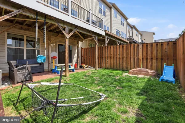 a view of a house with wooden deck and furniture