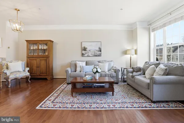 a living room with furniture a lamp and a table